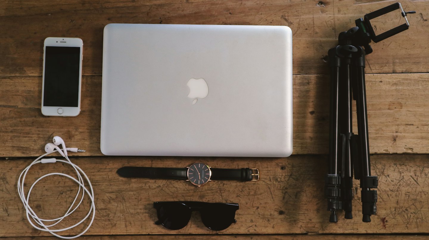 Modern tech accessories arranged on a wooden surface.